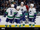 vancouver-canucks-right-wing-conor-garland-8-celebrates-his-open-goal-score-with-center-jt-mil...jpg